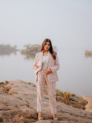 Woman wearing a pastel polka dot blazer and trouser set in a full-length pose